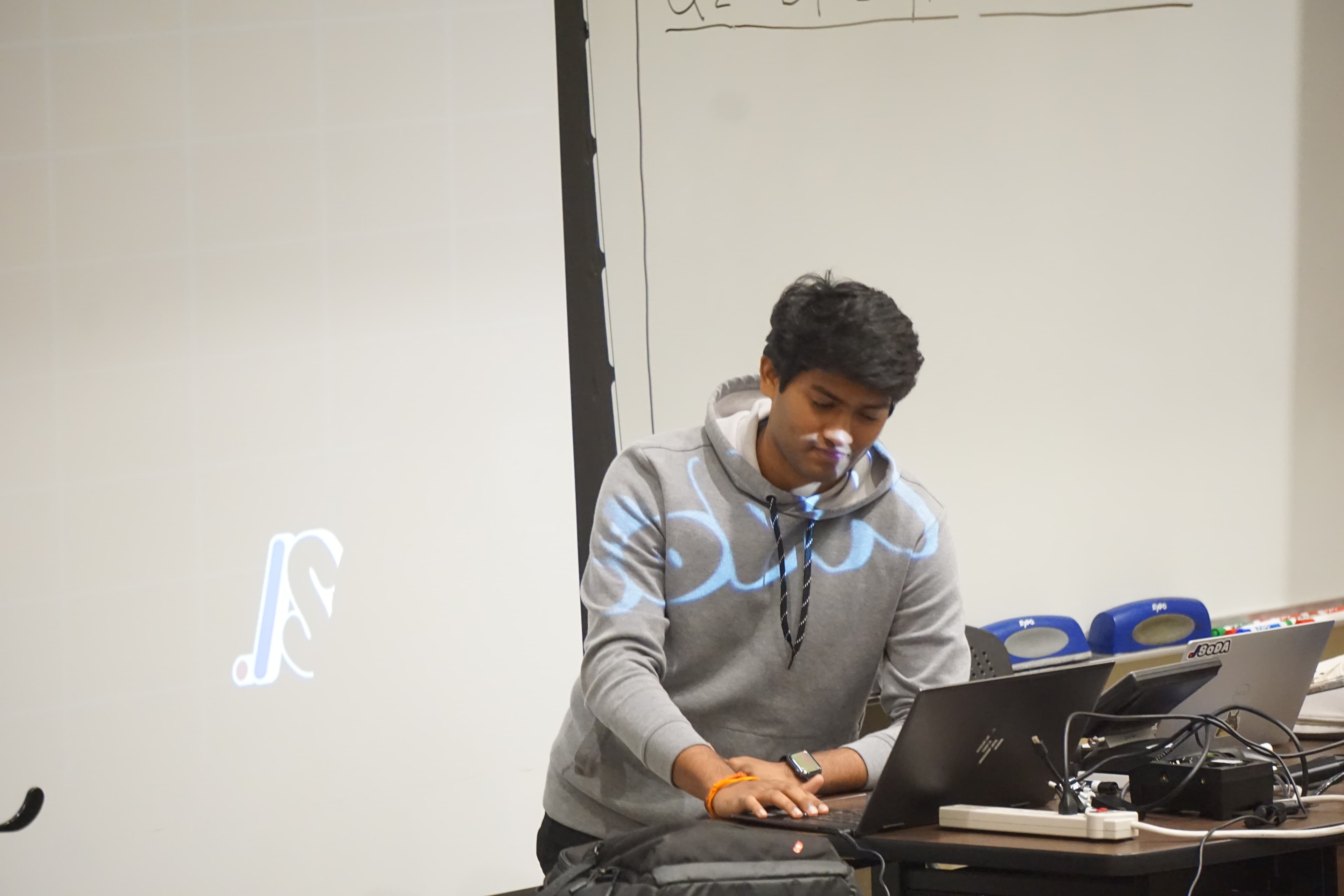 Sri working at a laptop during a student event